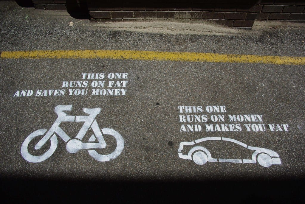 Image illustrates how bicycles are both cheaper and healthier than cars
