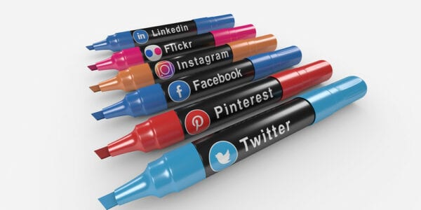 Picture of markers in a row with social media logos on them