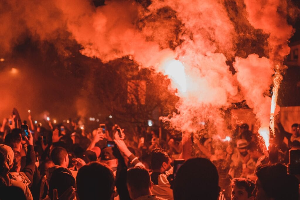 A political riot with angry people, violence and red flares