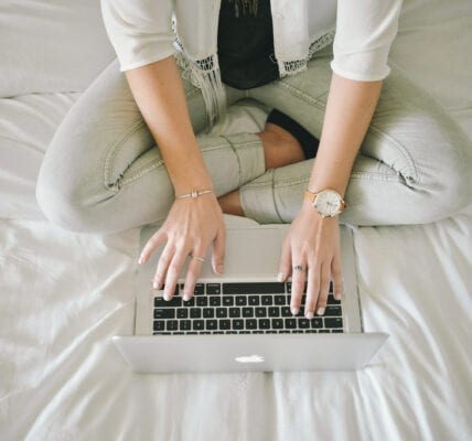 Image of a woman typing on her laptop.