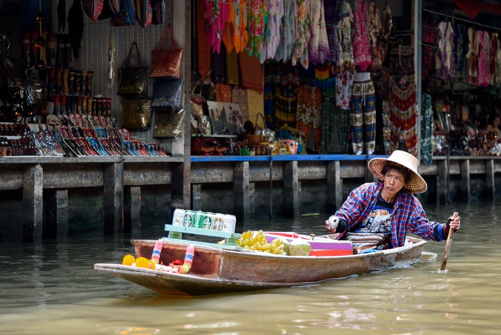 Image of a floating beer vendor on a canal in Thailand on a sunny day