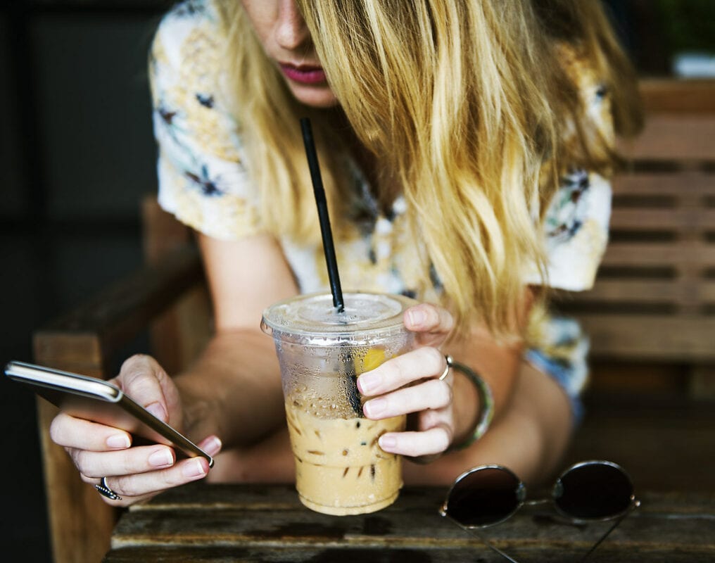 Female Instagram Influencer Holding Coffee and Phone