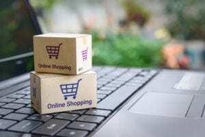 picture of two packages on top of a laptop titled online shopping