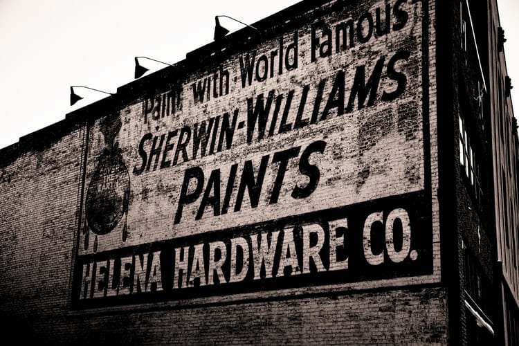 Image of an old billboard used to advertise a painting product  